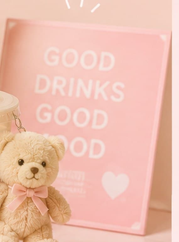 A pink sign reading Good Drinks Good Mood beside the counter